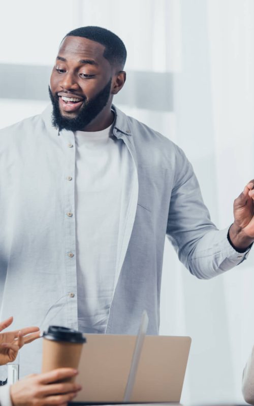 african-american-man-talking-with-colleagues-during-meeting-in-creative-agency.jpg