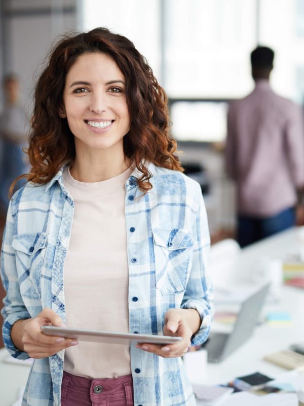 cheerful-young-woman-posing-in-creative-agency.jpg